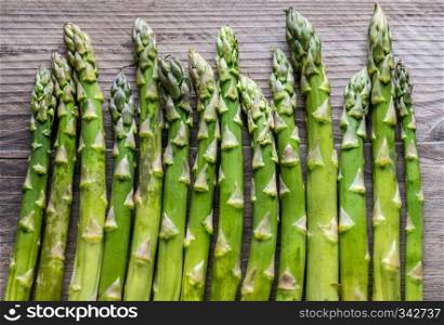Fresh asparagus on the wooden background