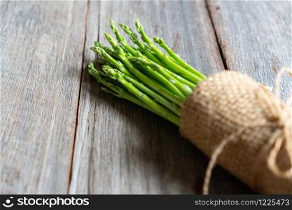 fresh asparagus on wooden background