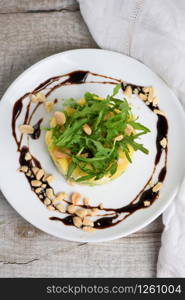 Fresh avocado, mango, mozzarella and arugula salad seasoned with nuts