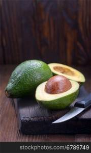 fresh avocado on wooden board and on a table