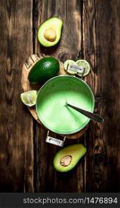 Fresh avocado sauce. On a wooden background.. Fresh avocado sauce. On wooden background.