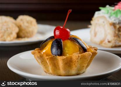 fresh baked cherry cupcake on a wooden table