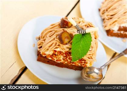 fresh baked chestnut cream cake dessert over rustic white wood table