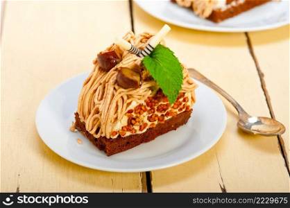 fresh baked chestnut cream cake dessert over rustic white wood table 