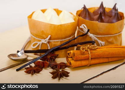 fresh baked chocolate vanilla and spices cream cake dessert over rustic wood table