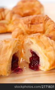 fresh baked croissant French brioche filled with berries jam