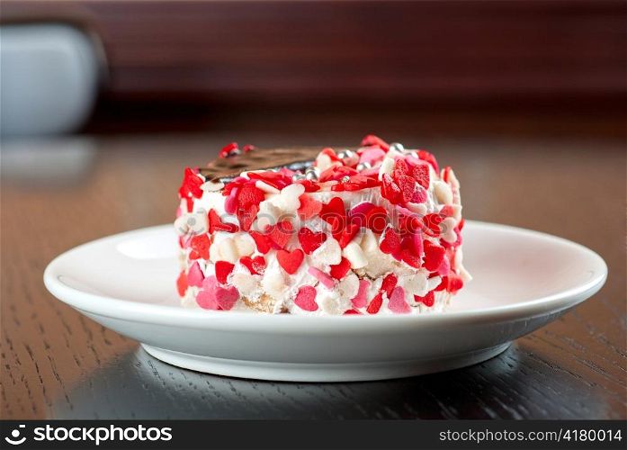 fresh baked cupcake with hearts on a wooden table