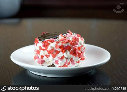 fresh baked cupcake with hearts on a wooden table