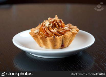 fresh baked cupcake with nuts on a wooden table