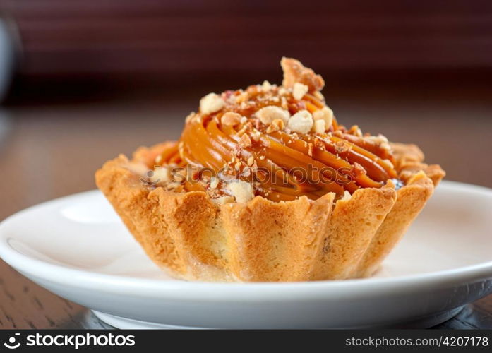 fresh baked cupcake with nuts on a wooden table