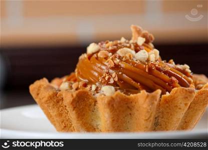 fresh baked cupcake with nuts on a wooden table