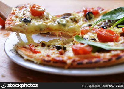 fresh baked pizza with olives and peppers