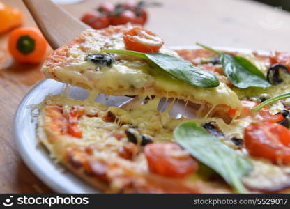 fresh baked pizza with olives and peppers