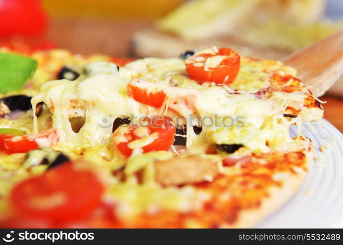 fresh baked pizza with olives and peppers