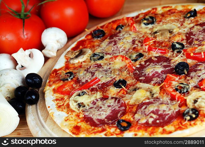 fresh baked pizza with pepperoni, olives and mushroom