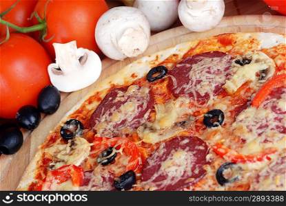 fresh baked pizza with pepperoni, olives and mushroom