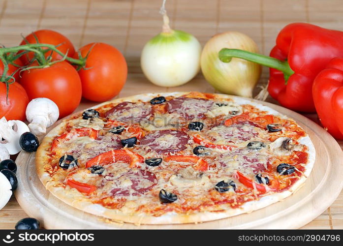 fresh baked pizza with pepperoni, olives and mushroom