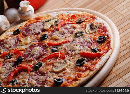 fresh baked pizza with pepperoni, olives and mushroom