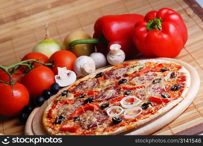 fresh baked pizza with pepperoni, olives and mushroom