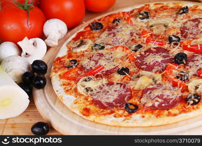 fresh baked pizza with pepperoni, olives and mushroom