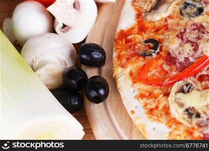 fresh baked pizza with pepperoni, olives and mushroom