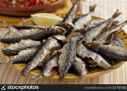 Fresh barbecued sardines on a dish