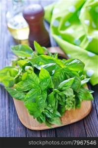 fresh basil on board and on a table