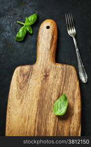 Fresh basil on dark wooden background