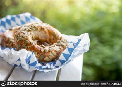 Fresh Bavarian Pretzels for breakfast, lying on a wooden table outdoors