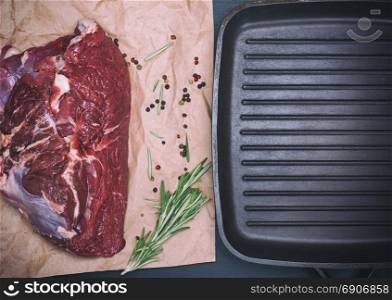 Fresh beef tenderloin and black square frying pan, top view