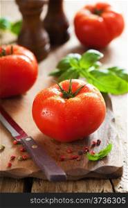 fresh beef tomatoes on cutting board
