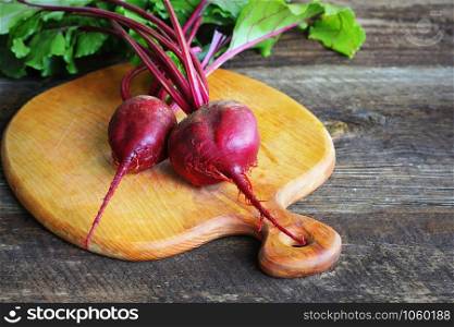 Fresh beetroot on rustic wooden background. Harvest vegetable cooking conception . Diet or vegetarian food concept .