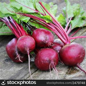 Fresh beetroot on rustic wooden background. Harvest vegetable cooking conception . Diet or vegetarian food concept .. Fresh beetroot on rustic wooden background. Harvest vegetable cooking conception . Diet or vegetarian food concept