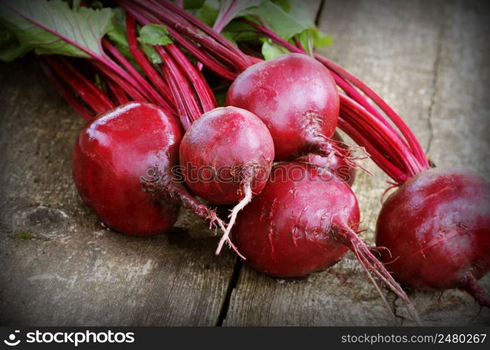 Fresh beetroot on rustic wooden background. Harvest vegetable cooking conception . Diet or vegetarian food concept .. Fresh beetroot on rustic wooden background. Harvest vegetable cooking conception . Diet or vegetarian food concept