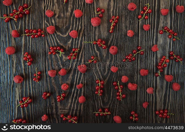 Fresh berries background. Fresh berries raspberry and red currant on wooden table for pattern