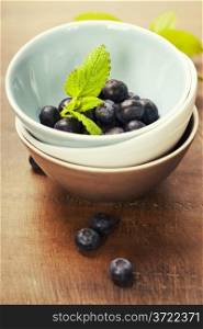 fresh berries in a bowl on wooden background