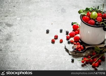Fresh berries in a cup on a stone stand. On the stone table.. Fresh berry in mug