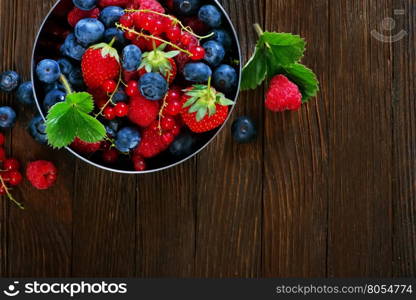 fresh berries in bowl and on a table