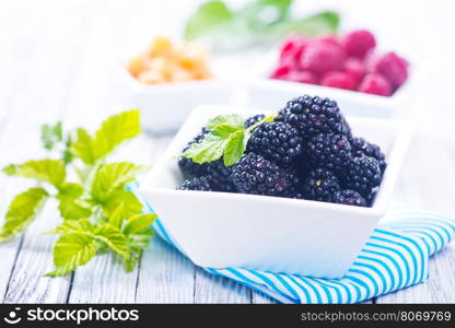 fresh berries in bowl and on a table