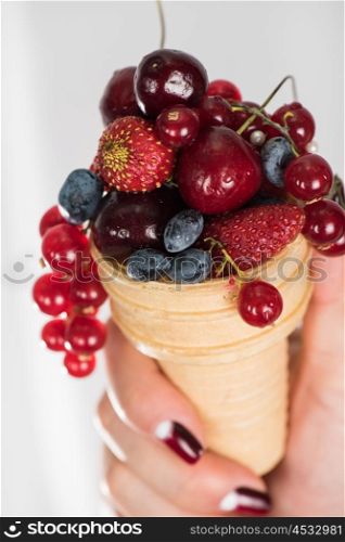 fresh berries in wafer. hand holding fresh berries in wafer