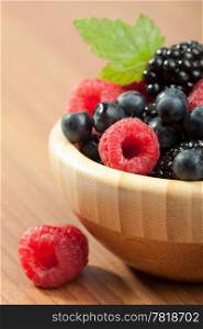 fresh berries in wood bowl