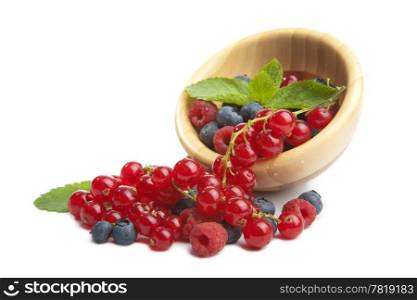 fresh berries in wood bowl isolated