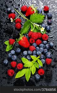 Fresh Berries on Dark Background. Strawberries, Raspberries and Blueberries. Health, Diet, Gardening, Harvest Concept