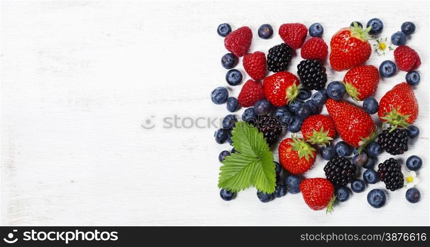 Fresh berries on old wooden background