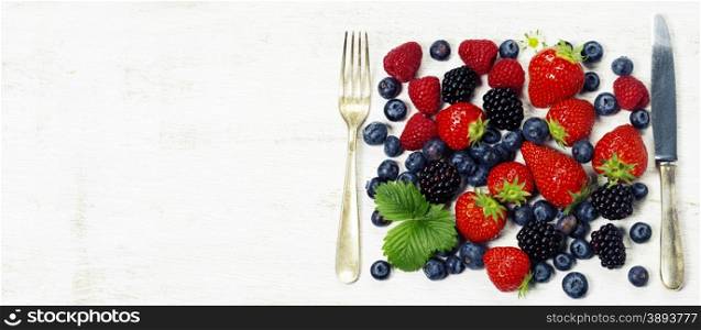Fresh berries on old wooden background