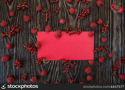 Fresh berries raspberry and red currant on wooden table, background for design