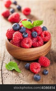 fresh berries raspberry blueberry in wooden bowl