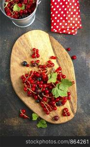 fresh berries, red currant on wooden board