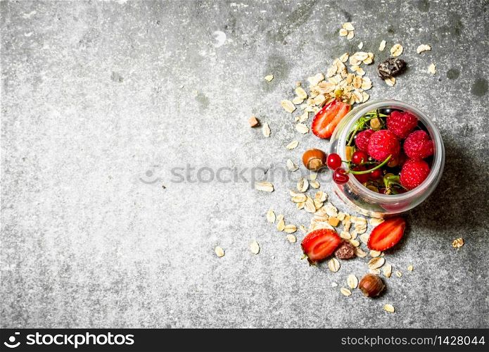 Fresh berries with muesli. On the stone table.. Fresh berries with muesli.