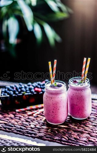 Fresh berry smoothies on mason jars